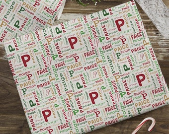May include: Beige wrapping paper with a repeating pattern of the name "Paige" in various sizes and colors, including red, green, and brown. The name is repeated in a word cloud style.