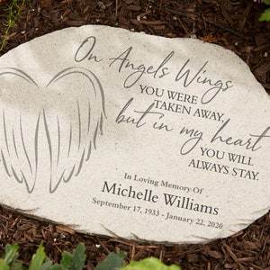 May include: A light gray stone memorial with the inscription "On Angels Wings...but in my heart...You will always stay." Features an angel wing design. Includes the name Michelle Williams and dates September 17, 1933 - January 22, 2020.