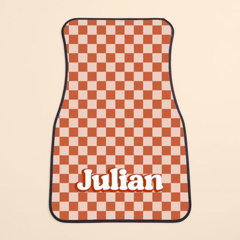 May include: Checkered car floor mat with a red and white pattern and the name "Julian" in a retro font.
