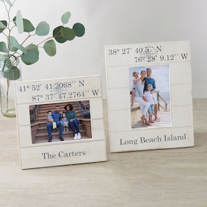 May include: Two white wooden picture frames with a nautical theme. The top frame has the coordinates 38° 27' 40.5" N 76° 28' 9.12" W and the text "Long Beach Island". The bottom frame has the coordinates 41° 52' 41.2068" N 87° 37' 47.2764" W and the text "The Carters".