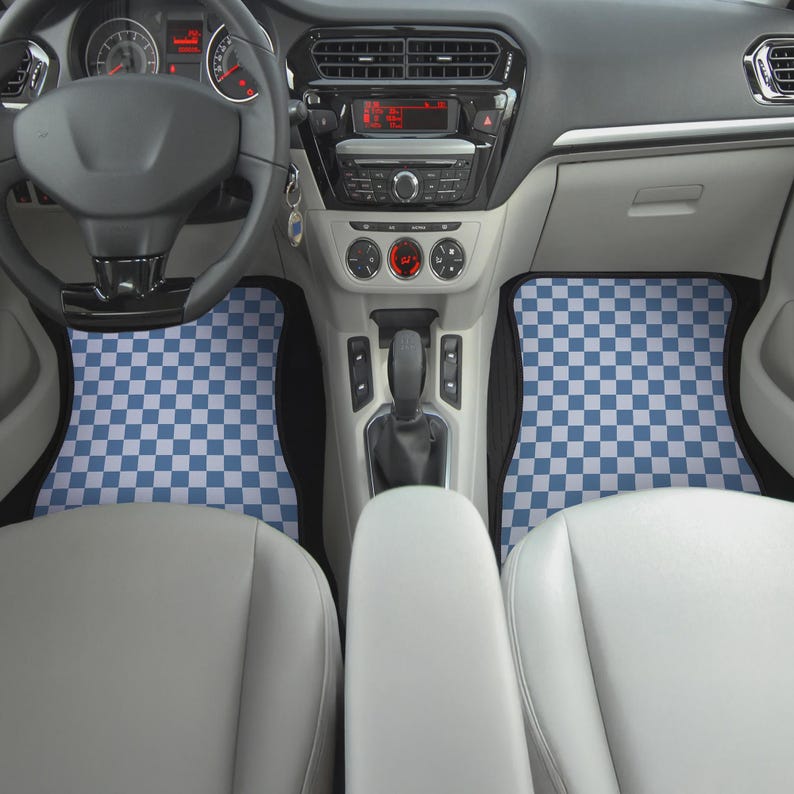 May include: Checkered blue and white car floor mats in a car interior. The mats are in the front passenger and driver's side of the car.