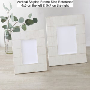 May include: Two white vertical shiplap picture frames, one 4x6 inches and one 5x7 inches, on a light wood surface.