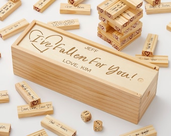 May include: Wooden box with a heart and the text "I've fallen for you!" engraved on the lid. The box contains wooden blocks with handwritten messages on them, such as "Give me a smile", "Good for one butterfly kiss", and "Hugs & Kisses".