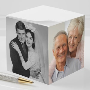 May include: A black and white photo of a couple on their wedding day, and a color photo of the same couple, now older, smiling and hugging.