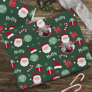 May include: Green wrapping paper with a repeating pattern of Santa Claus, candy canes, presents, and snowflakes. The paper also features the name "Molly" and the phrase "Ho! Ho! Ho!" in a speech bubble.