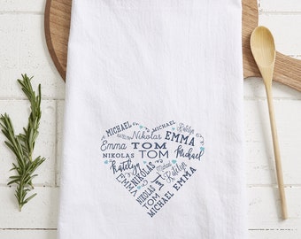 May include: White kitchen towel with a blue heart design featuring the names Michael, Katelyn, Nikolas, Emma, and Tom. The names are arranged in a heart shape with small blue hearts scattered around the design.