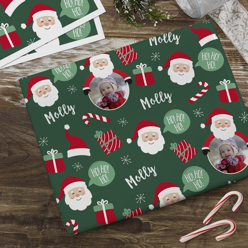 May include: Green wrapping paper with a repeating pattern of Santa Claus, candy canes, presents, and the name "Molly".