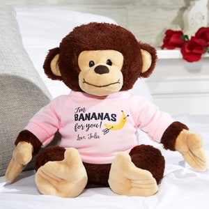 May include: A brown plush monkey wearing a pink shirt with the text "I'm BANANAS for you! Love, Julie".
