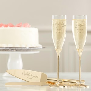 May include: Gold wedding champagne flutes with the names Michelle and Jason engraved on them, along with the words "Bride" and "Groom" and the date 12.04.25. A gold cake knife with the names Michelle and Jason engraved on it, along with the date 12.04.25.