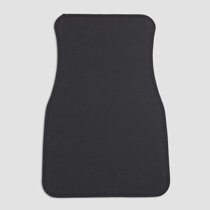 May include: Black car floor mat with a textured surface.