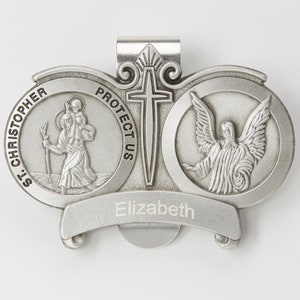May include: Silver-toned metal religious charm with a depiction of Saint Christopher carrying a child, a guardian angel with wings, and a cross. The charm has the words "Protect Us" and "St. Christopher" inscribed on it. The charm also has the name "Elizabeth" engraved on it.