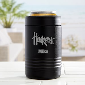 May include: Black insulated can cooler with a silver inscription that reads "Huskers" and "Mike".