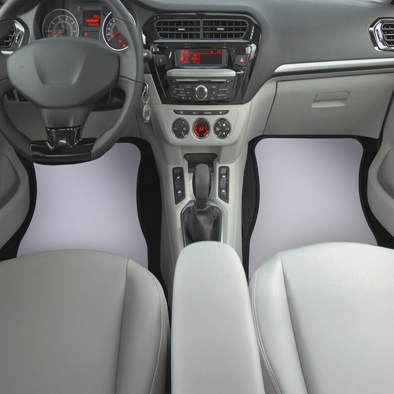 May include: A black steering wheel with a silver trim and a black dashboard with a silver trim. The car has a black center console with a silver gear shift knob and a black and silver radio.