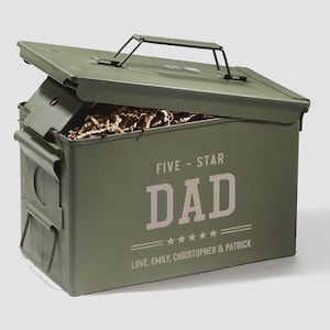 May include: An olive green metal ammunition box with a hinged lid and a top carrying handle. The front features the text FIVE-STAR DAD above five stars and the text LOVE, EMILY, CHRISTOPHER & PATRICK. The box is partially open, revealing brown paper filler.