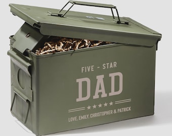 May include: An olive green metal ammunition box with a hinged lid and a top carrying handle. The front features the text FIVE-STAR DAD above five stars and the text LOVE, EMILY, CHRISTOPHER & PATRICK. The box is partially open, revealing brown paper filler.