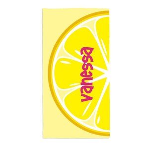 May include: A yellow beach towel with a large lemon slice graphic and the name "Vanessa" written in pink letters.