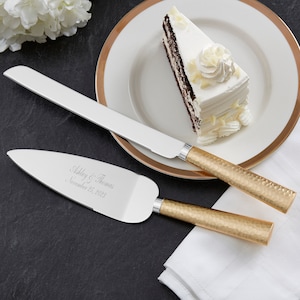 May include: Gold hammered cake knife and server set with a personalized inscription reading "Ashley & Thomas, November 25, 2023".