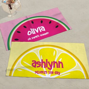 May include: Two beach towels with a watermelon and lemon design. The watermelon towel is pink with the text "Olivia oh sweet summer". The lemon towel is yellow with the text "ashlyn squeeze the day".