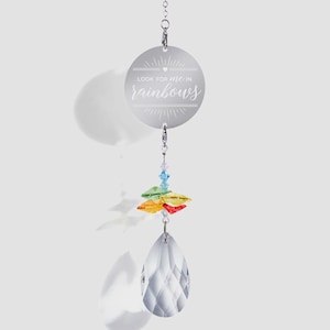 May include: A hanging suncatcher ornament featuring a circular silver metal disc engraved with the text Look for me in rainbows. Below the disc are small blue, green, yellow, and red crystal beads attached to a large, clear, faceted teardrop crystal.