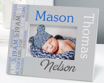 May include: A gray picture frame with the name "Mason" in blue and "Nelson" in script. The frame holds a photo of a sleeping baby wearing a knit hat. The frame also includes the baby's birth details: date, time, weight (3 oz 8 lbs), and length (22 inches).