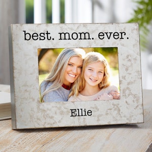 May include: A silver picture frame with the text "best. mom. ever." and a personalized name "Ellie" at the bottom. The frame has a photo of a mother and daughter smiling.