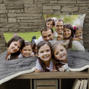 May include: Four throw pillows with a family photo printed on each. The pillows are arranged in a stack, with the largest pillow on the bottom and the smallest pillow on top. The photo on the largest pillow shows a family of five, including two parents and three children. The photo on the second largest pillow shows a close-up of the two youngest children. The photo on the third largest pillow shows a close-up of the two oldest children. The photo on the smallest pillow shows a close-up of the father.