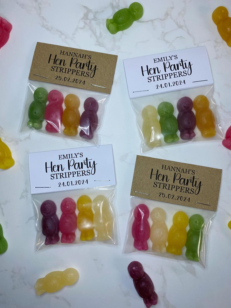 May include: Four small bags filled with colorful candy, each bag has a personalized tag with the text "Hen Party Strippers" and a date.