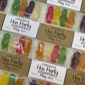May include: A set of small, clear plastic bags filled with colorful jelly candies. Each bag has a white label with the text "Chelsea's Hen Party Strippers May 2024".