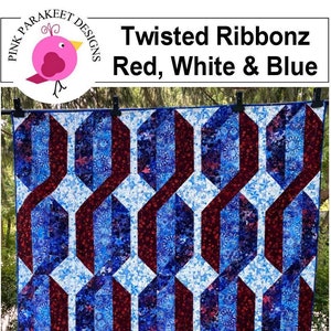 Könnte beinhalten: Eine Decke mit einem geometrischen Muster in Rot, Weiß und Blau. Die Decke ist mit einer schnellen Streifen-Patchwork-Technik hergestellt. Die Decke hängt an einer Wäscheleine im Freien.