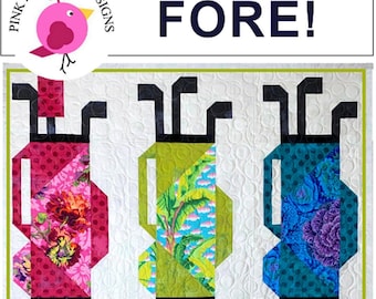 May include: A quilt pattern featuring six golf bags made from colourful fabric scraps. The quilt is titled "FORE!" and is labelled "Fat Quarter Friendly".