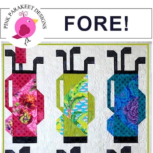May include: A quilt pattern featuring six colorful golf bags with black handles. The quilt is white with a subtle pattern. The text "FORE!" is at the top of the quilt and "Fat Quarter Friendly" is at the bottom.