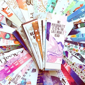 May include: A collection of colorful bookmarks with various designs and patterns. Some bookmarks feature text, including "My personality is 85% the last book I read".