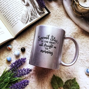 May include: A silver glitter mug with a black design that reads "Second Star to the Right and straight on til morning".