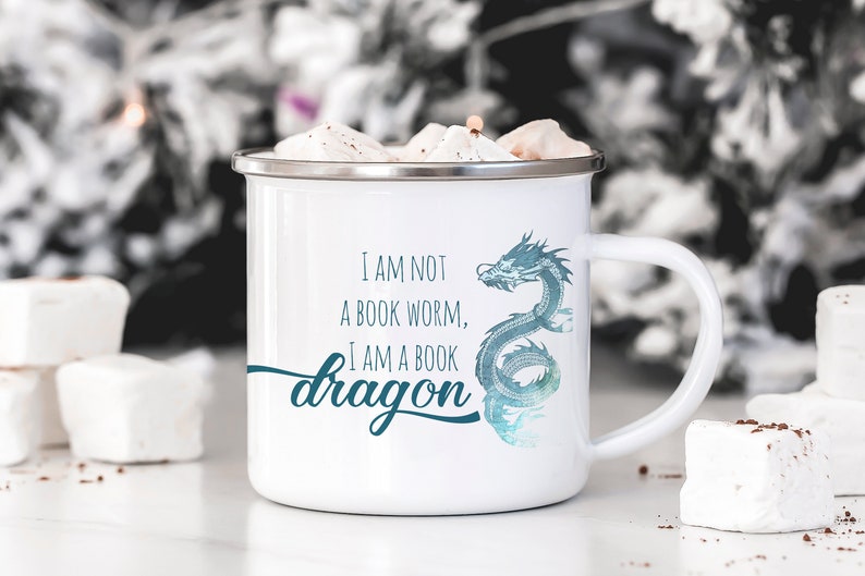 May include: White enamel mug with a blue and green dragon design and the text "I am not a book worm, I am a book dragon".