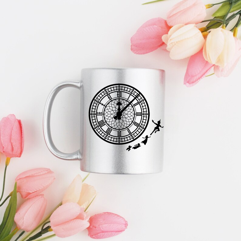 May include: A silver mug with a black silhouette of Big Ben and Peter Pan flying around it.