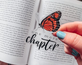 May include: A clear sticker with a butterfly design and the text "one more chapter" in black script. The sticker is on a book with a white background.