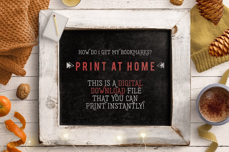 May include: A chalkboard with white trim, sitting on a wooden surface. The chalkboard has the text "HOW DO I GET MY BOOKMARKS? PRINT AT HOME" written in white chalk. Below the text is a message in red chalk that says "THIS IS A DIGITAL DOWNLOAD FILE THAT YOU CAN PRINT INSTANTLY!"