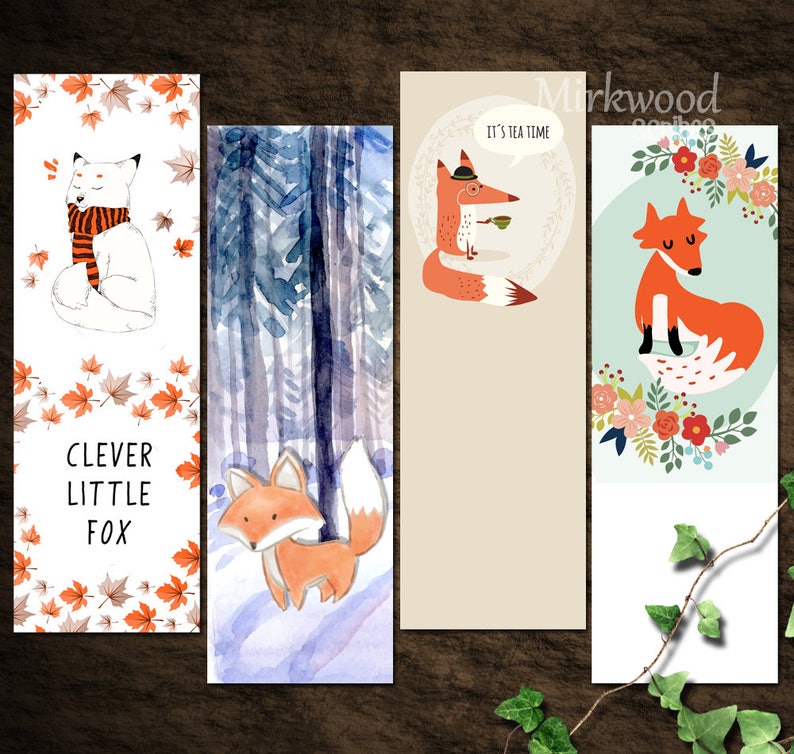 May include: Set of four fox-themed bookmarks. The first bookmark features a white fox with a scarf and orange leaves. The second bookmark features a fox walking through a forest. The third bookmark features a fox wearing a hat and holding a teacup with the text "It's tea time". The fourth bookmark features a fox sitting on a floral wreath.
