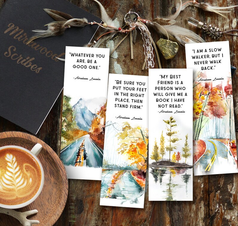 May include: Four watercolor bookmarks with inspirational quotes by Abraham Lincoln. Each bookmark features a different landscape scene with fall colors, including a mountain road, a river, a forest, and a road through a field.