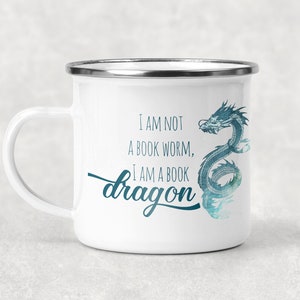 May include: White enamel mug with a blue watercolor dragon design and the text "I am not a book worm, I am a book dragon".