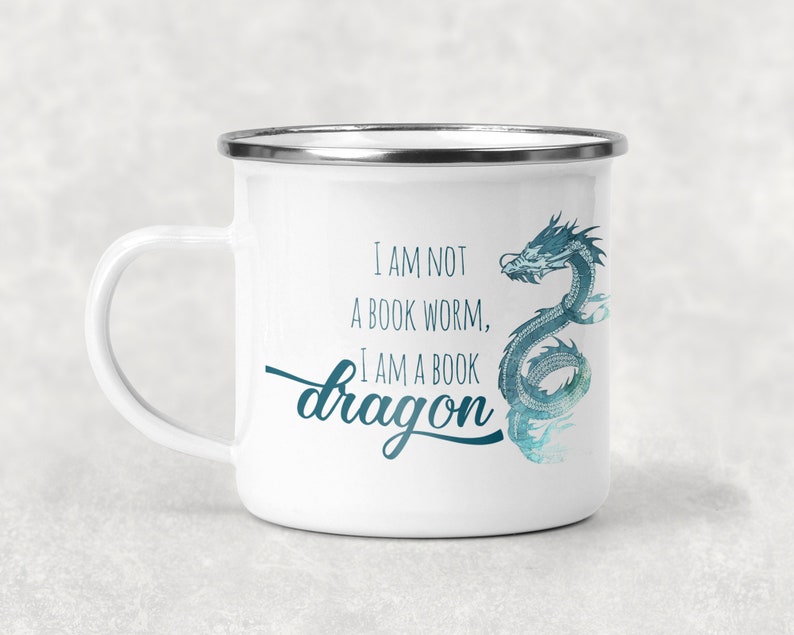 May include: White enamel mug with a blue watercolor dragon design and the text "I am not a book worm, I am a book dragon".