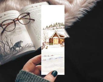 May include: A watercolor bookmark featuring a cozy cabin with a warm glow in the windows, surrounded by snow-covered trees and a snowy landscape. The cabin has a brown wooden exterior with white trim and a red roof.
