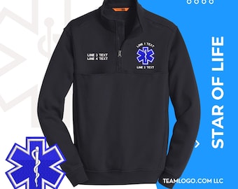 May include: Black quarter-zip pullover with a blue and white embroidered Star of Life logo and the text "LINE 1 TEXT", "LINE 2 TEXT", "LINE 3 TEXT", and "LINE 4 TEXT".