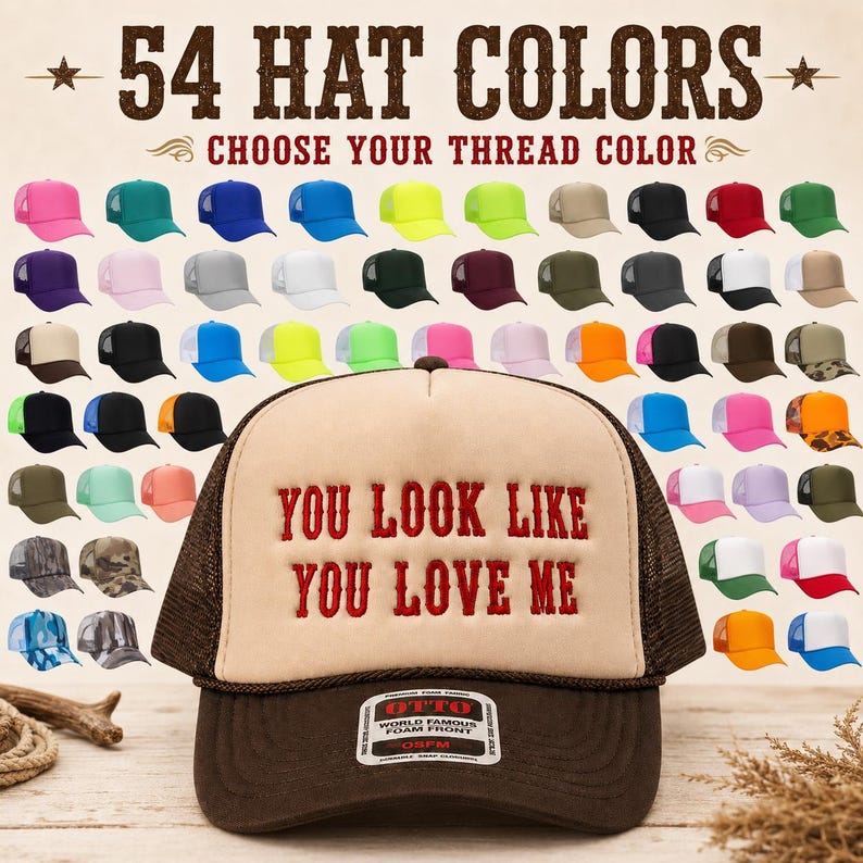 May include: A foam front trucker hat with a brown mesh back and a dark brown brim. The front panel is beige with the red embroidered text "YOU LOOK LIKE YOU LOVE ME". An Otto brand sticker is on the brim. The background displays 54 hat color options.