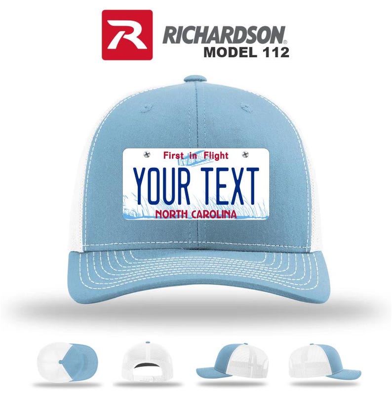 May include: Light blue and white trucker hat with a license plate design. The hat features the text "YOUR TEXT" and "NORTH CAROLINA" on the front. The top of the hat is light blue, with a white mesh back. The Richardson Model 112 logo is visible.
