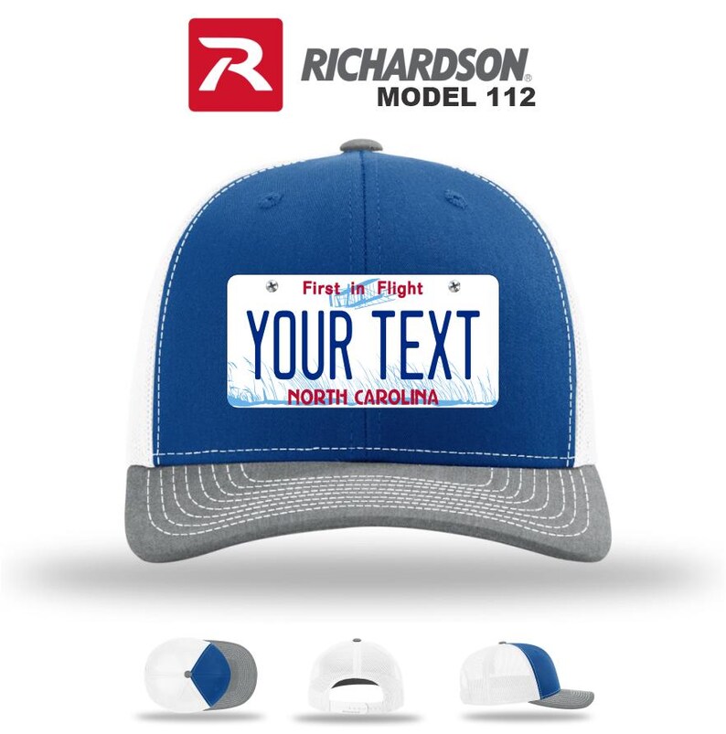 May include: A blue and white trucker hat with a gray brim. The hat features a license plate design with the text "YOUR TEXT" and "NORTH CAROLINA". The hat is a Richardson Model 112.