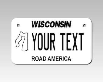 Personalized Wisconsin License Plate 4" X 7" (inches) Aluminum. Road America White with black text