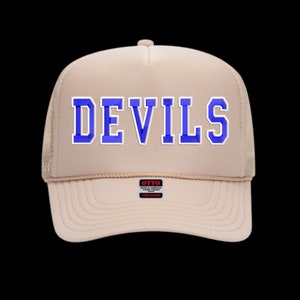 May include: A beige trucker hat with a blue embroidered "DEVILS" logo on the front. The hat has a mesh back and a black "OTTO" label.