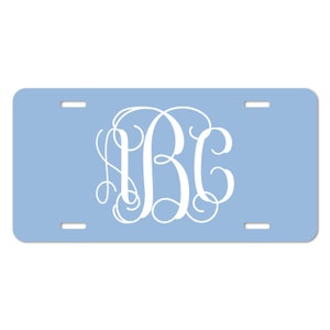 May include: Light blue personalized license plate with white monogrammed initials "ABC" in a script font.