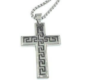 May include: A silver chain necklace with a silver cross pendant. The cross has a black Greek key design.